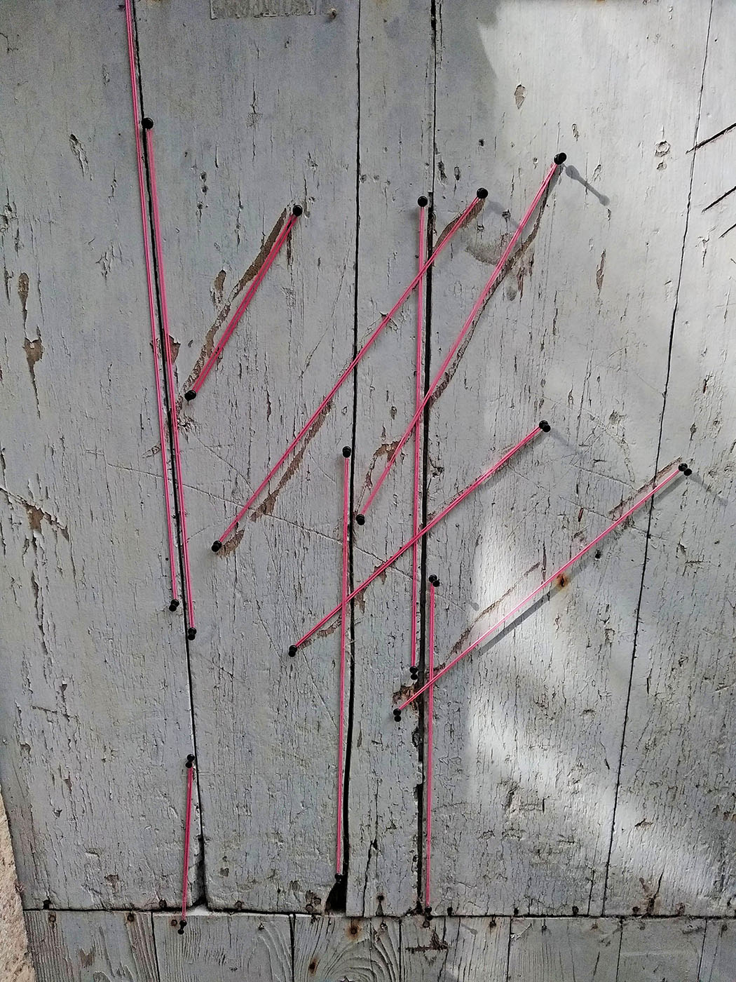 Detail of pink elastic construction among branches