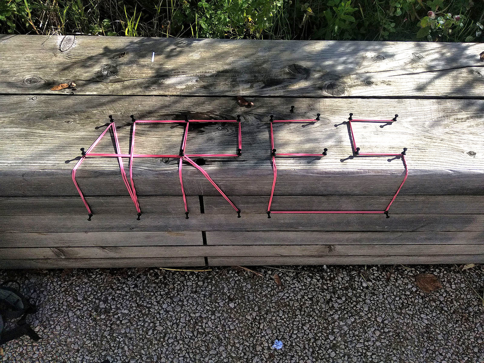 APRÈS in pink cord on a wooden bench